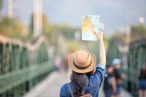 Female tourists on hand have a happy travel map.